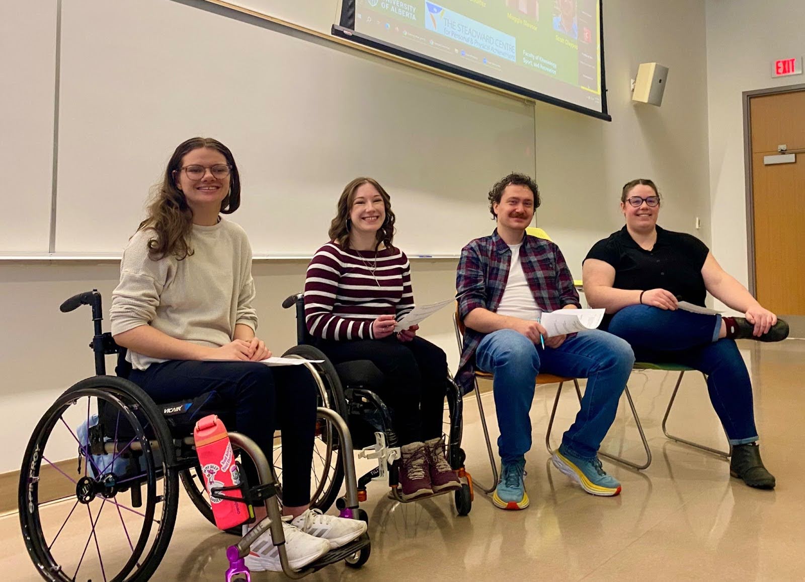 4 people seated and posing for a picture.