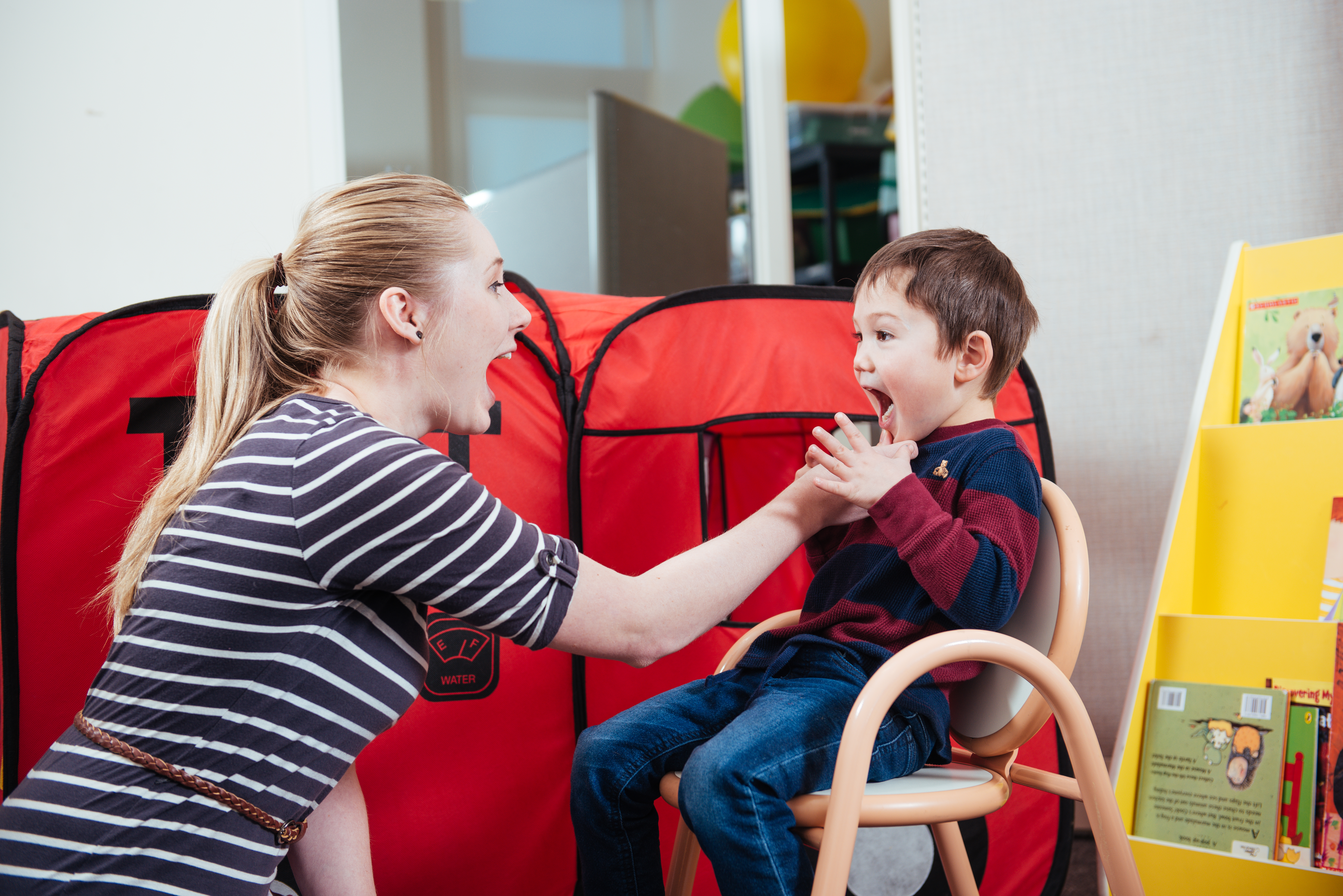 Woman helping a child talk